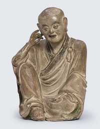 YUAN MING DYNASTY A RARE POLYCHROME STONEWARE FIGURE OF NAGASENA
